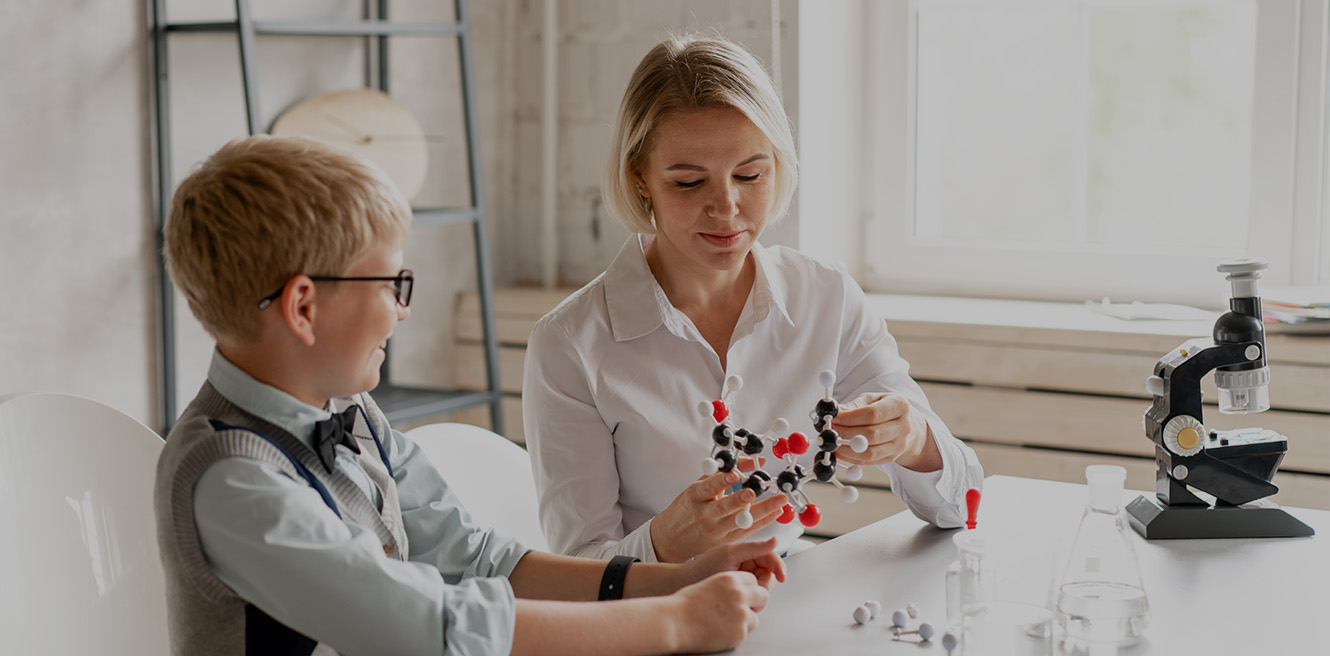 Female science tutor in Raleigh studying chemistry with student